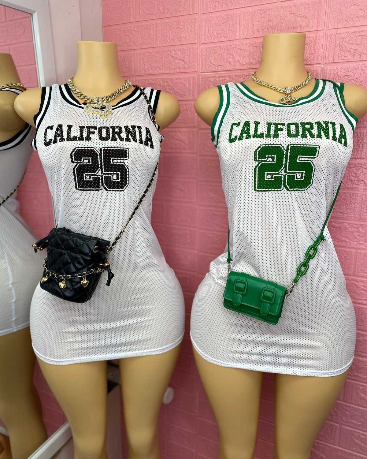 Two mannequins wearing white mesh athletic mini dresses styled as basketball jerseys.