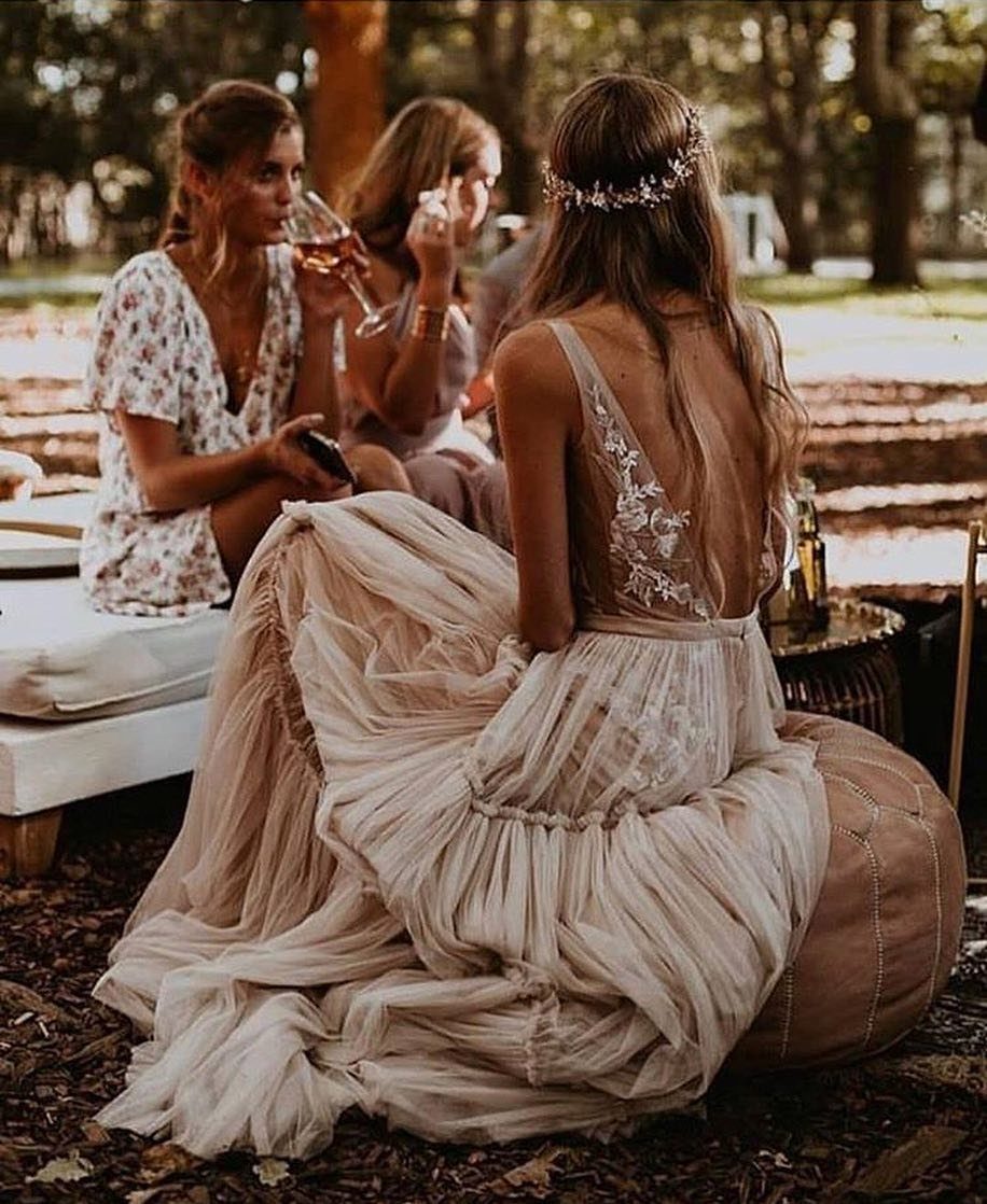 Boho Wedding Dress Looks: 8 Ideas from Lace to Chiffon 3 Woman in a flowing cream chiffon boho wedding dress sitting outdoors in nature.