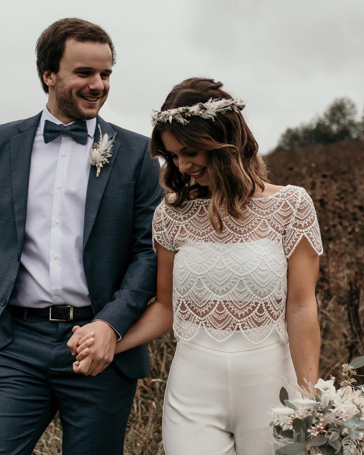 Bride Reception Dress: 17 Ideas for Your Second Look 6 Bride in white lace crop top and trousers with groom in blue suit.