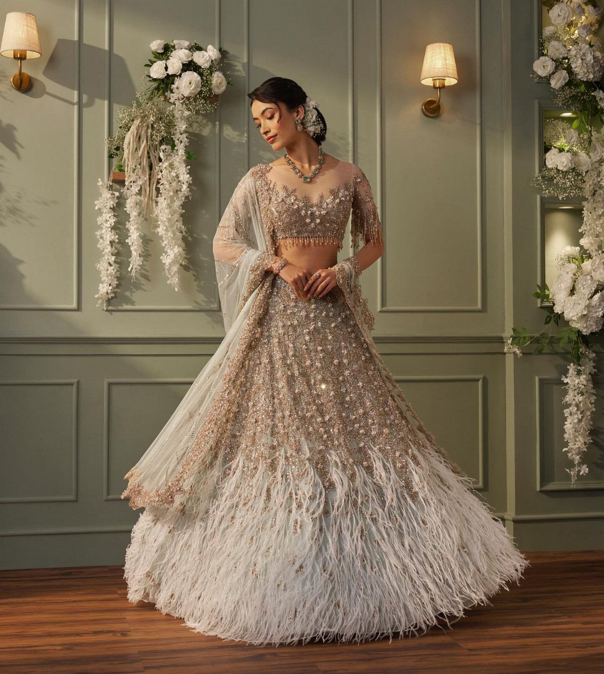 Bride Reception Dress: 17 Ideas for Your Second Look 2 Woman in a sparkling champagne bridal lehenga with white feather trim on the skirt.