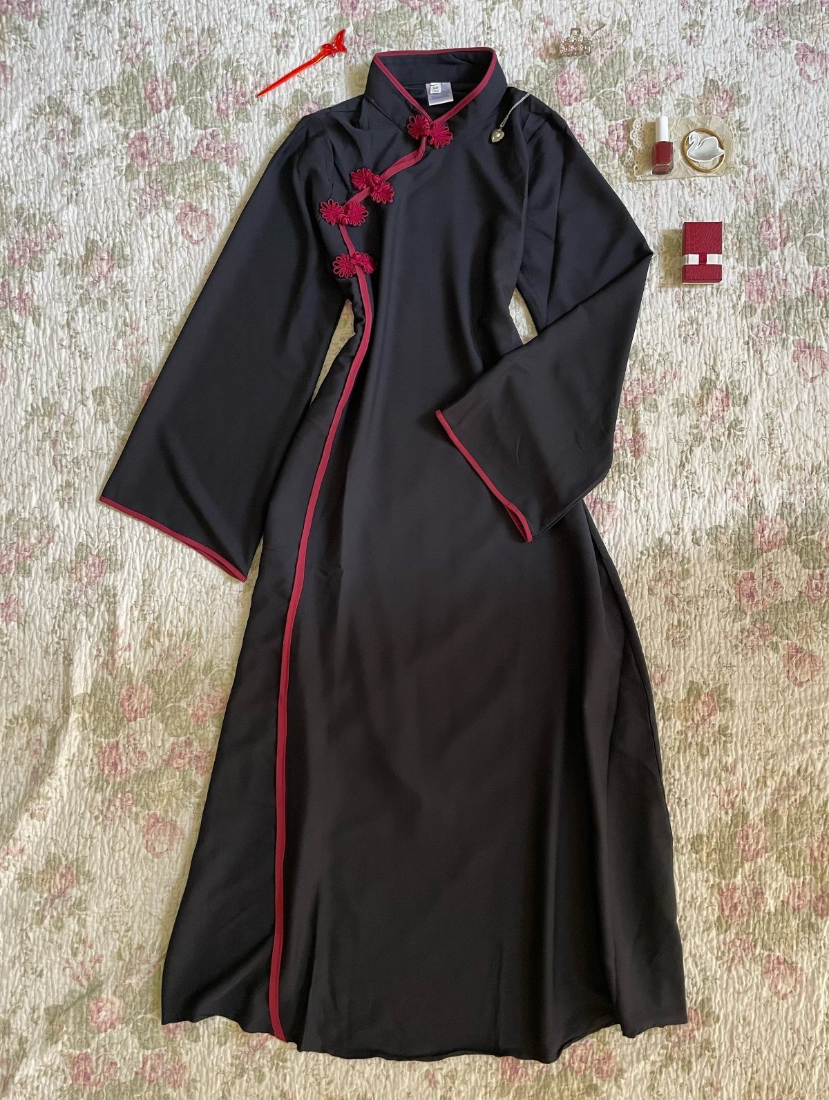 Black Chinese dress with red piping and frog buttons on floral fabric