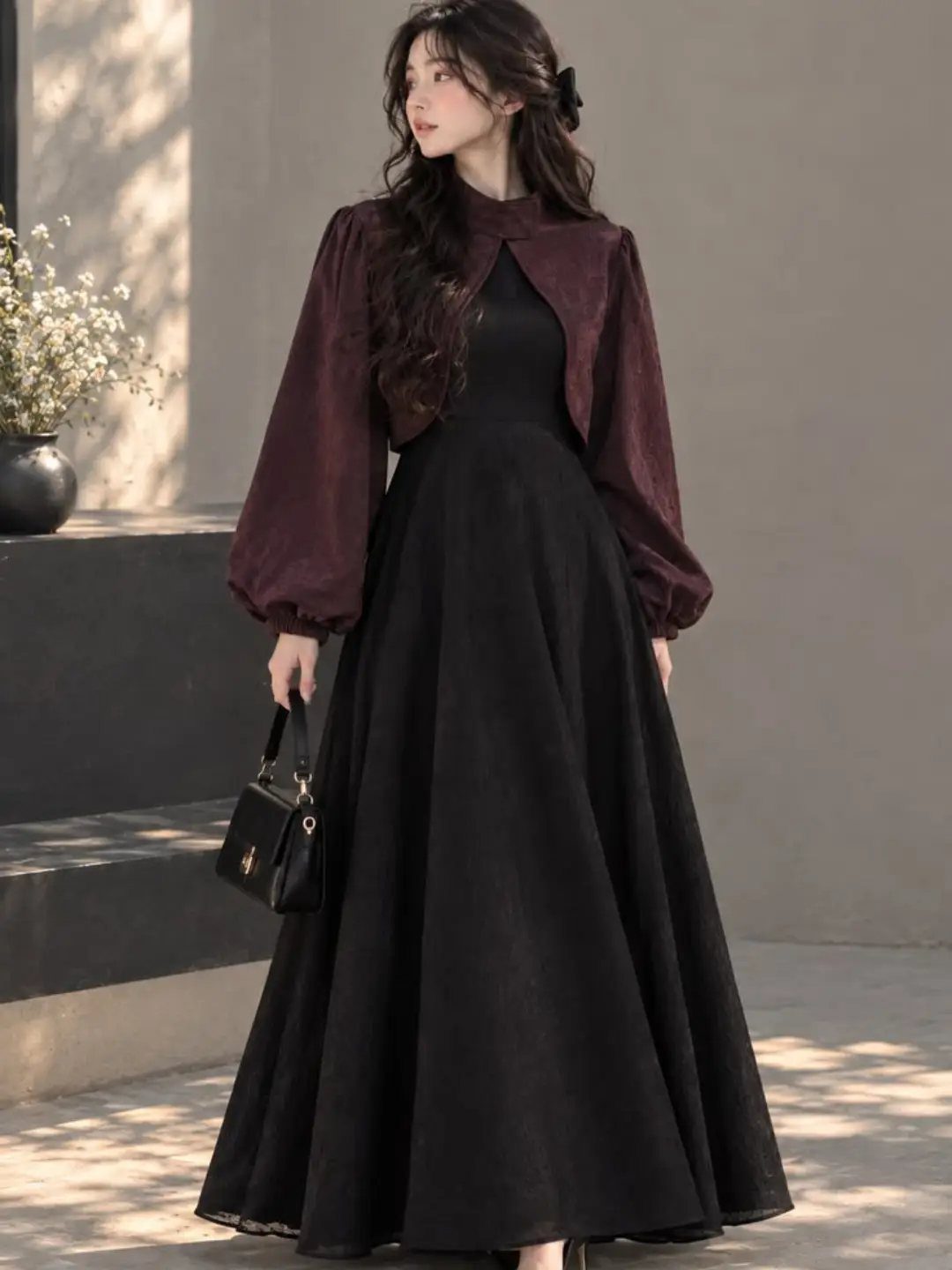 Classy Winter Dresses in 14 Timeless Styles 2 Woman in a long black fit and flare dress with a maroon shrug.