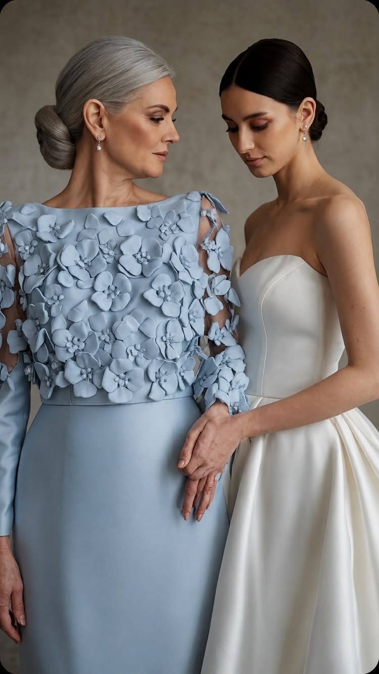 Elegant Dresses for Wedding Guests Over 50 (8 Refined Styles) 7 Older woman in a light blue floral elegant dress standing with a bride