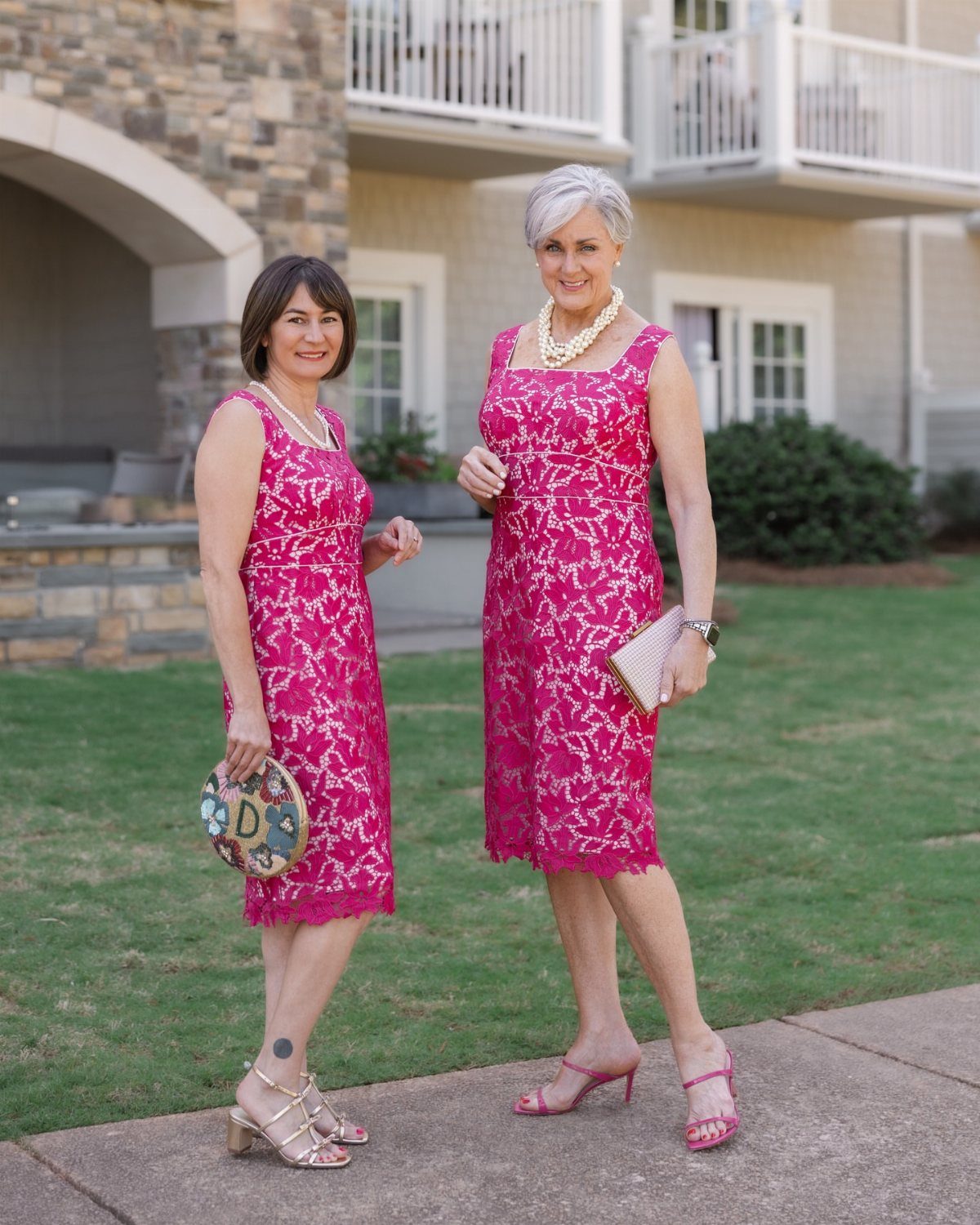 Elegant Dresses for Wedding Guests Over 50 (8 Refined Styles) 4 Two mature women wearing elegant bright pink lace dresses and high heel sandals.