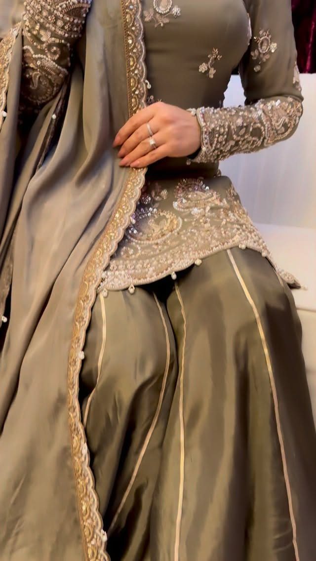 Greyish-green sharara suit with gold embroidery, wide-legged pants, and a matching dupatta.