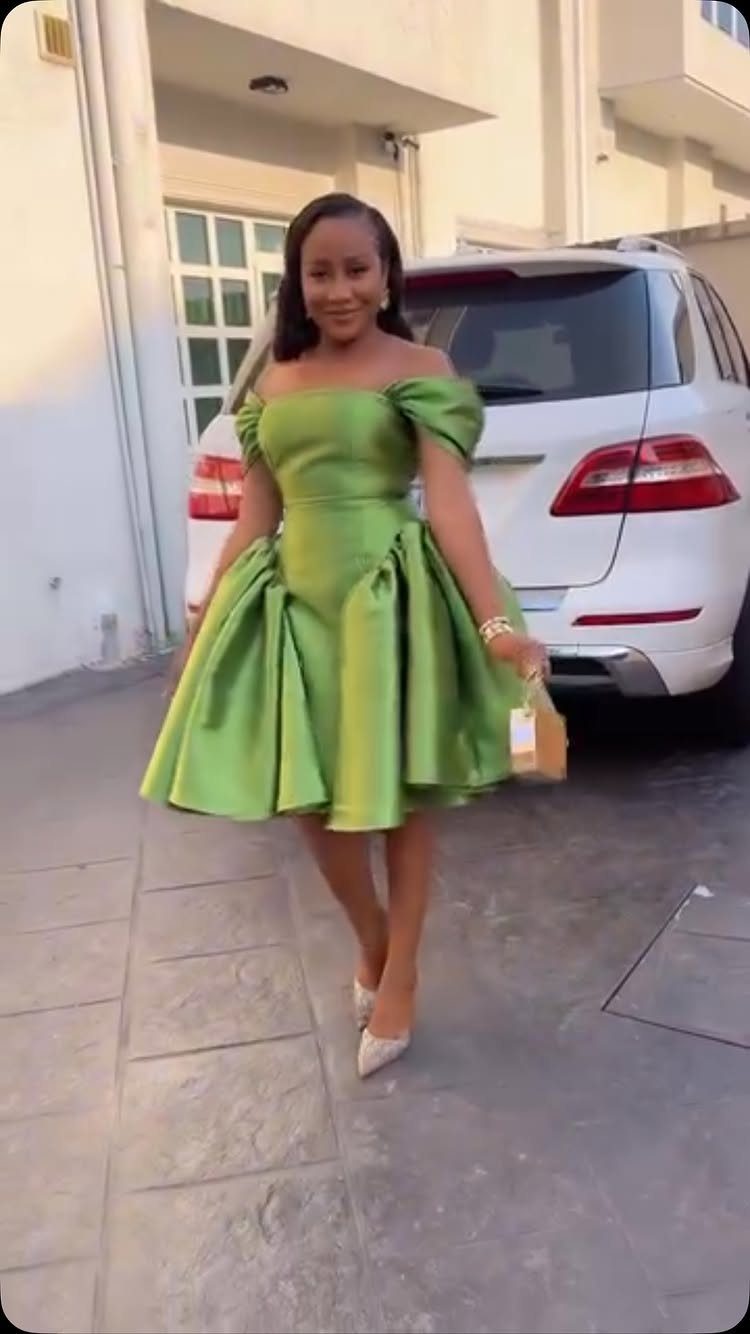 Knee-Length Cocktail Dress Styles: 15 Chic Ideas 3 Woman in a lime green off-the-shoulder fit-and-flare cocktail dress standing by a white car