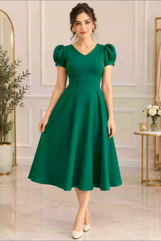 Knee-Length Cocktail Dress Styles: 15 Chic Ideas 8 Woman in a green knee-length cocktail dress with puff sleeves in a bright room