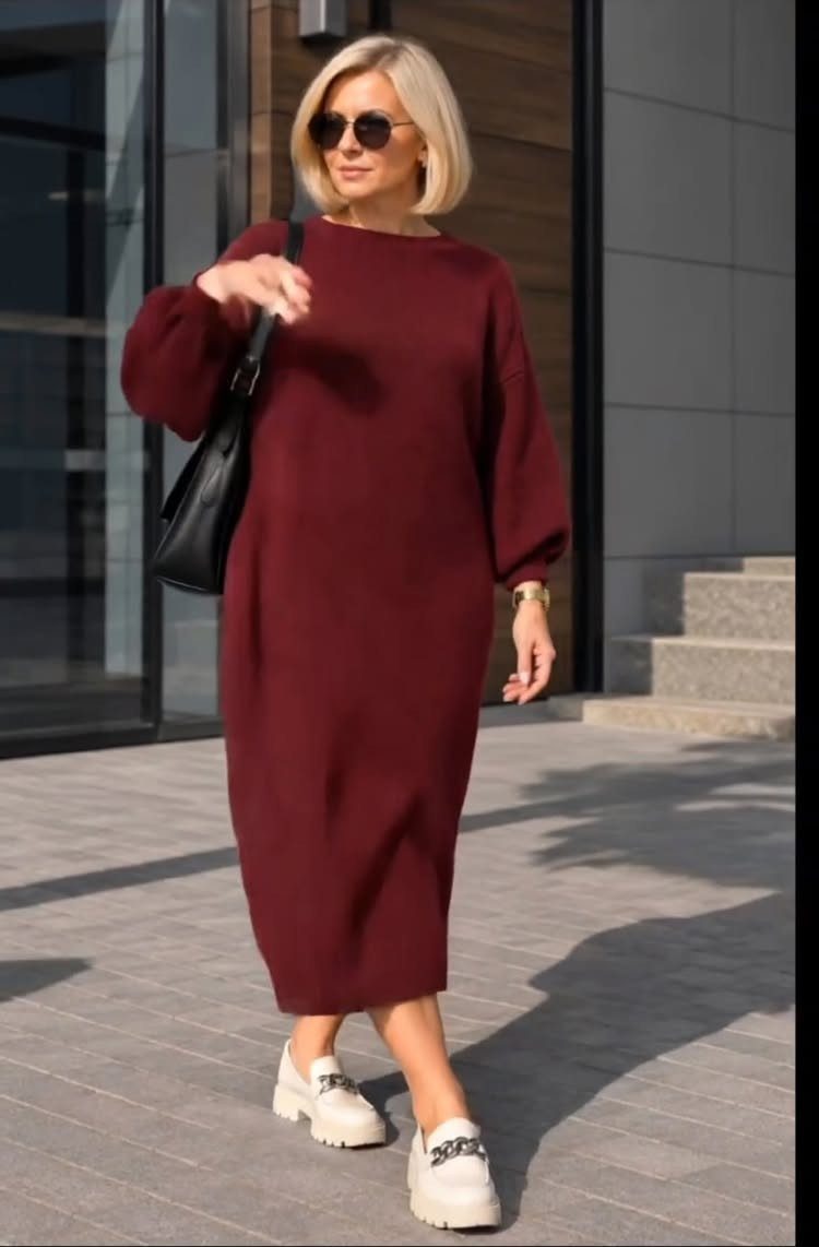 Woman wearing a burgundy midi casual dress and white sneakers outdoors.