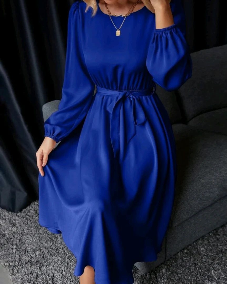 Royal Blue Colour Dress Styles: 7 Elegant Options to Try 2 Royal blue satin dress with long sleeves and a belted waist on a person.