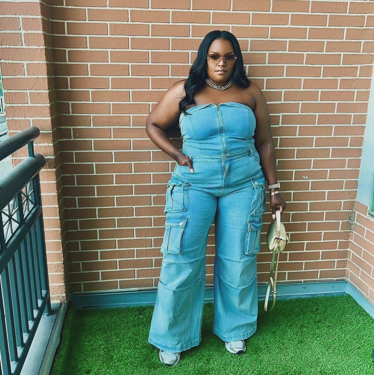 6 Spring Break Dresses to Pack for Your Next Getaway 6 Woman in a strapless light-blue denim cargo jumpsuit standing against a brick wall.