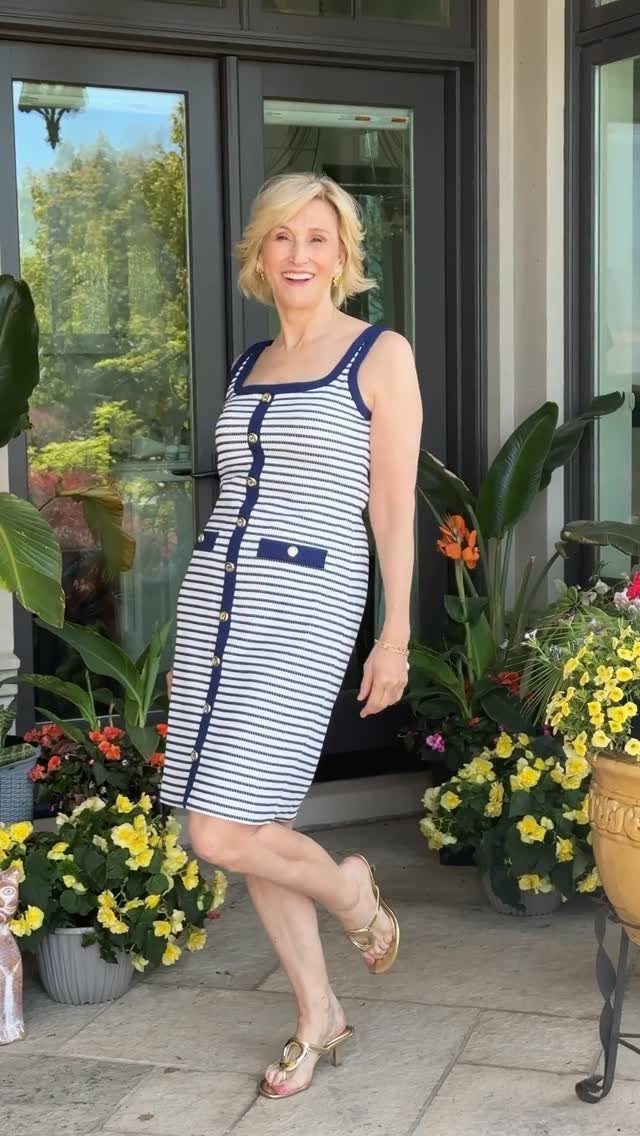 Are Summer Tank Dresses the Season's Must-Have? 8 Styles 4 Woman wearing a blue and white striped tank dress and gold sandals outdoors.