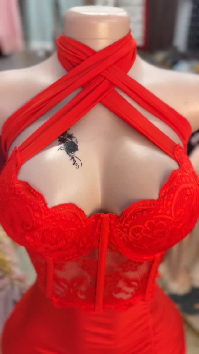 Red lace dress with criss-cross neck straps displayed on a mannequin.