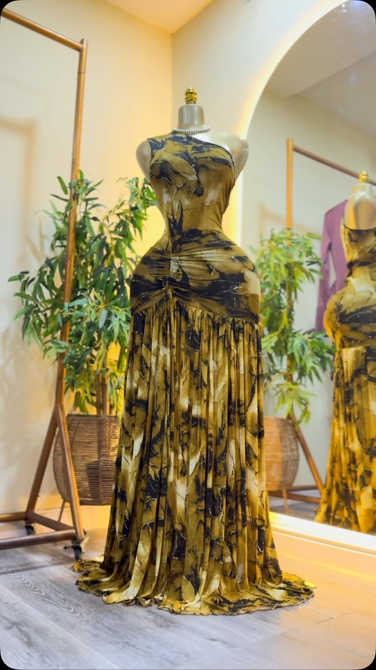 Strapless yellow and black marbled gown on a mannequin in a bright room