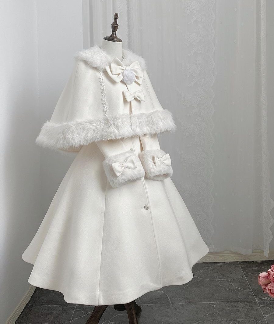 White winter dress and cape with faux fur trim on a mannequin