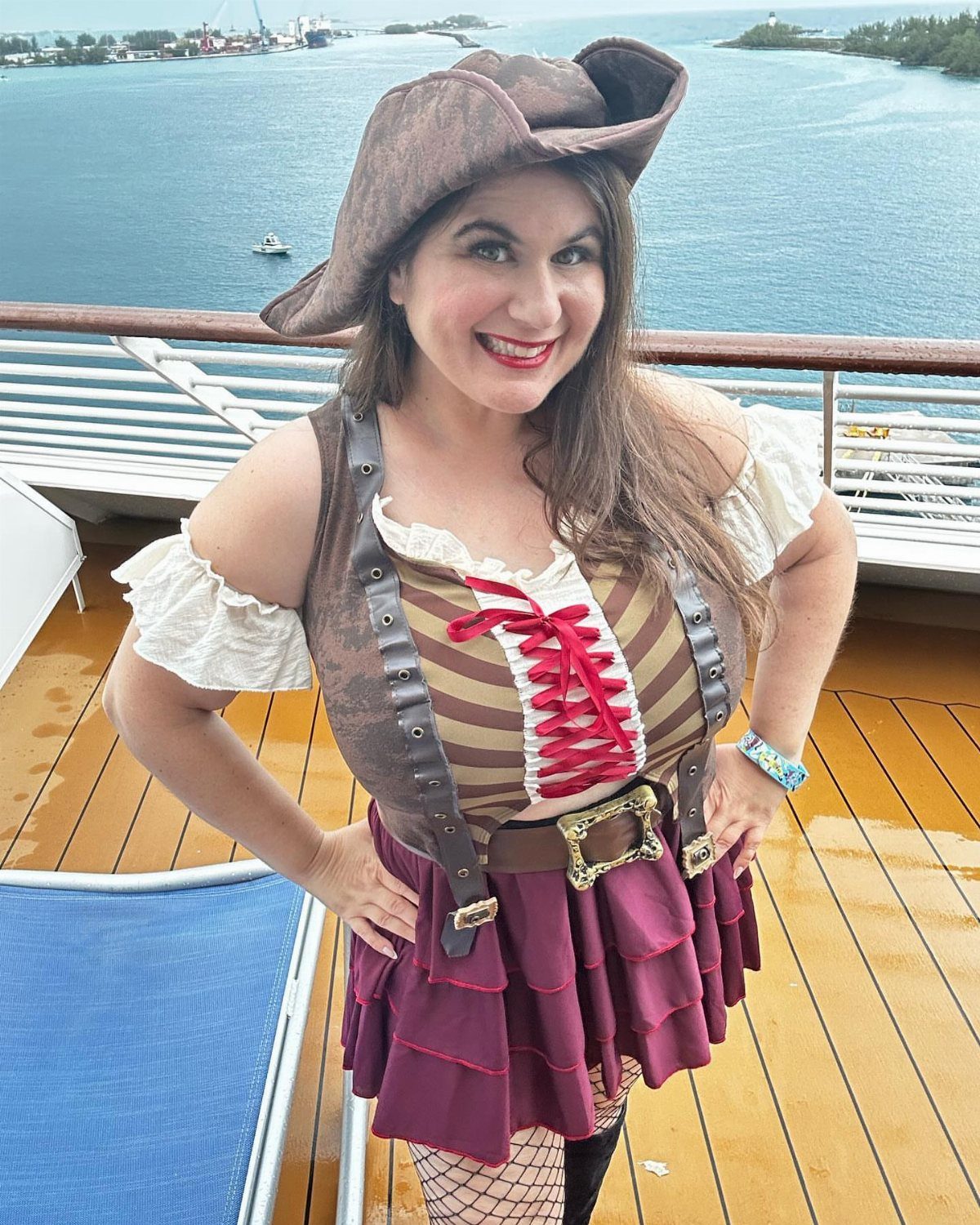 Womens Pirate Dress Styles: 8 Looks from Classic to Bold 1 Plus size woman in a pirate costume with a hat and maroon skirt on deck.