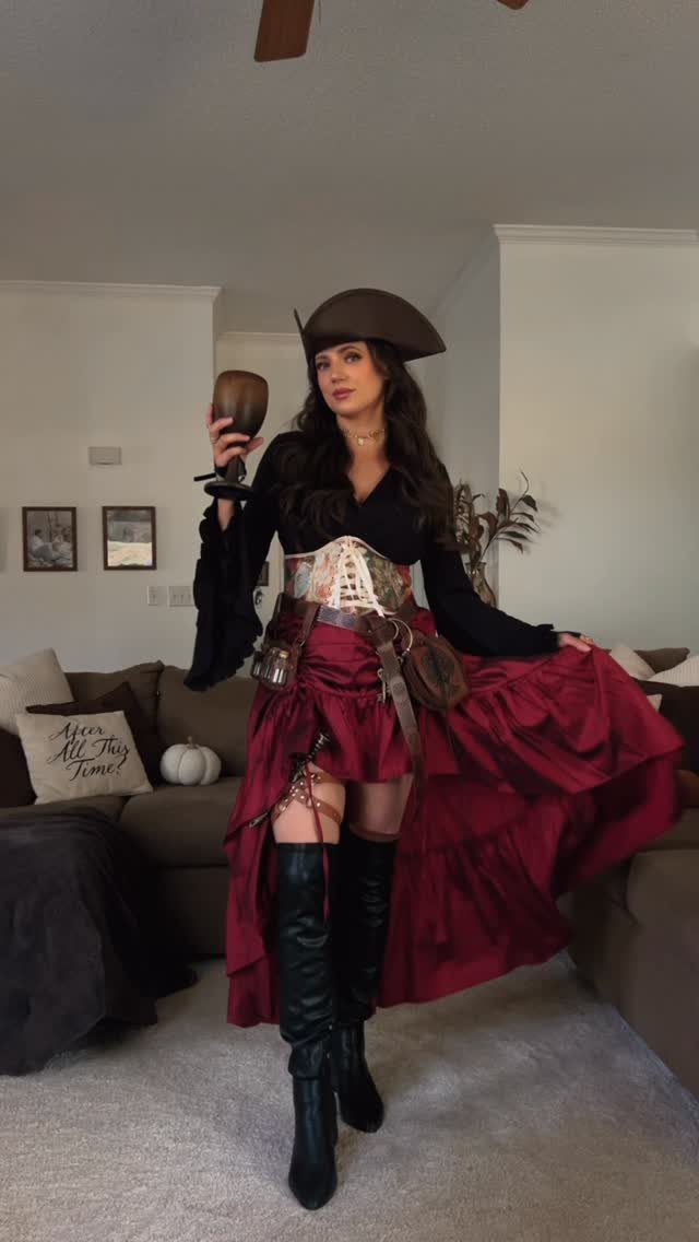Womens Pirate Dress Styles: 8 Looks from Classic to Bold 4 Woman in a pirate dress with a red skirt, corset, and tricorne hat.