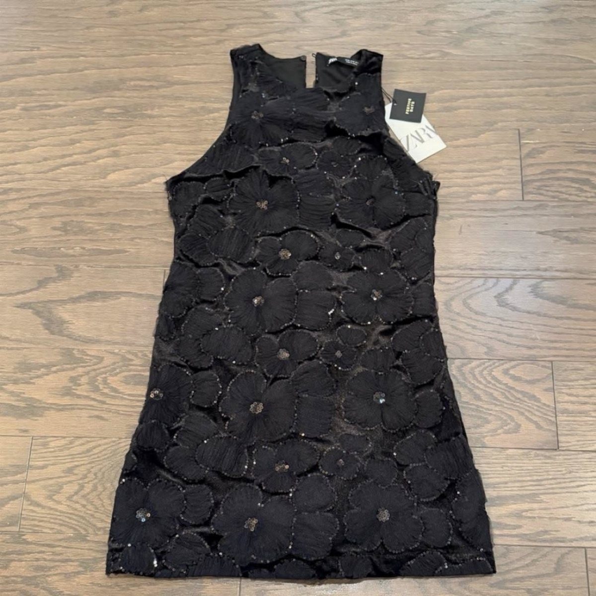 10 Zara Party Dresses to Wear This Season 4 Black sleeveless mini dress with 3D floral sequins on a wooden floor