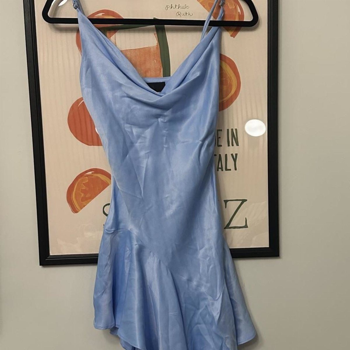 10 Zara Party Dresses to Wear This Season 1 Light blue satin mini dress with cowl neck and spaghetti straps on a hanger.